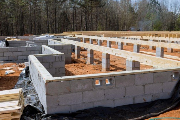 Concrete block foundation with floor framing system installed during new home construction in Parma Heights, OH