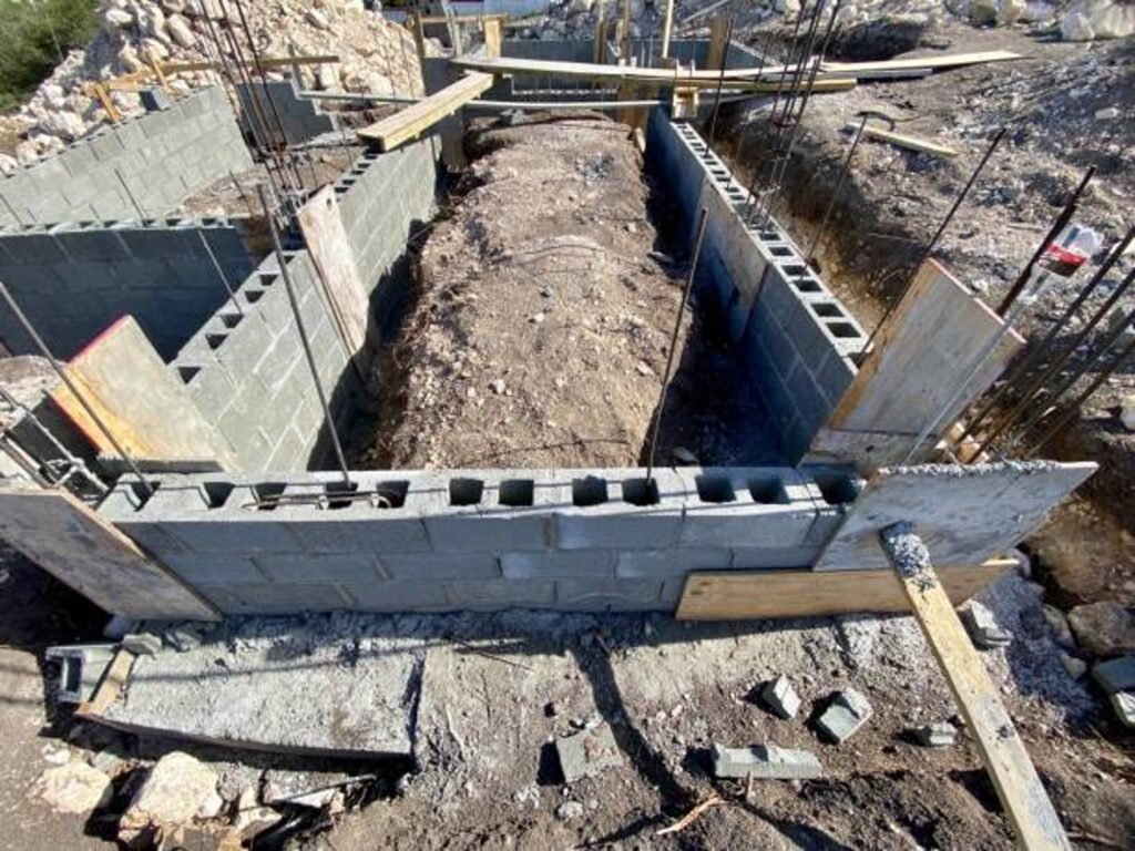 Concrete foundation installation with block walls and framing setup on the construction site in Parma Heights, OH